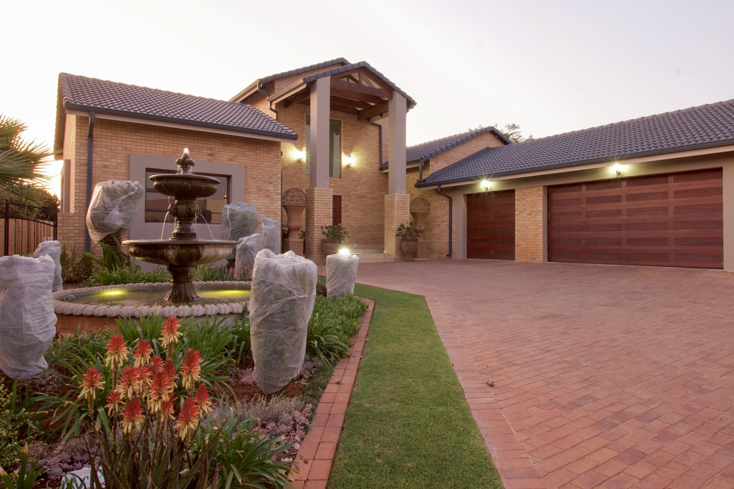 A water fountain in front of a house.